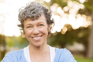 Smiling senior woman with dental implants