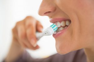 A woman brushing her teeth.